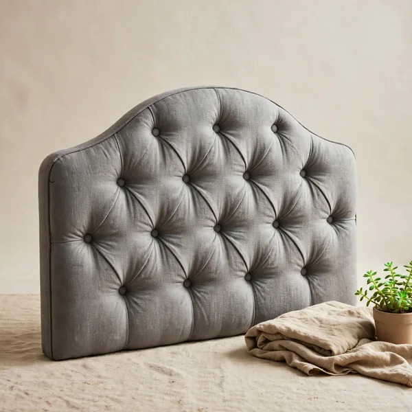 A curved tufted headboard
